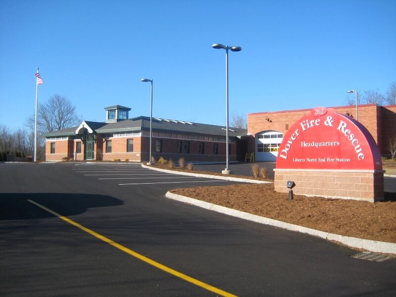Exterior of the Dover Fire & Rescue headquarters building and its red entrance sign in daylight, Dover, New Hampshire