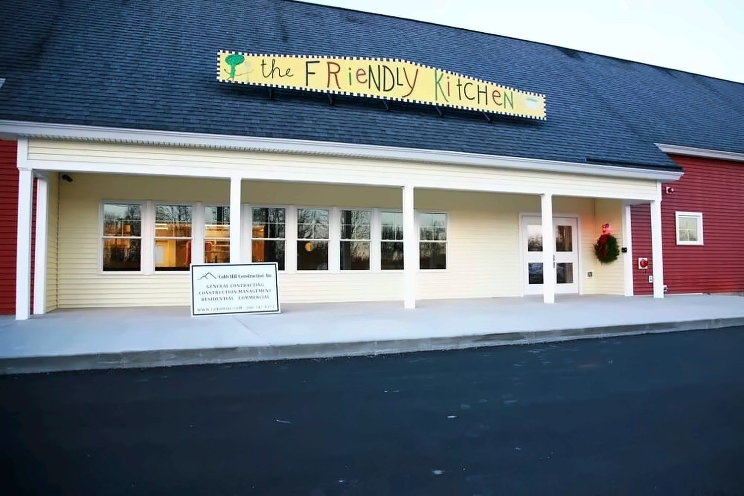 Completed red clapboard exterior of The Friendly Kitchen community soup kitchen building in Concord, New Hampshire