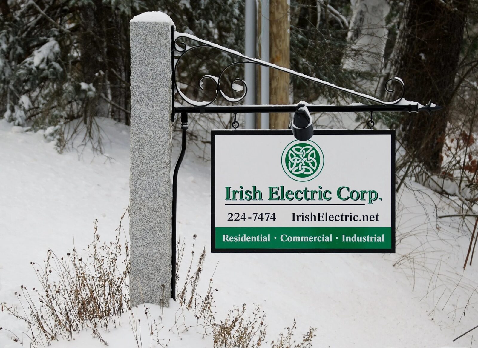 Irish Electric roadside sign in the snow in Hopkinton, New Hampshire, reading 224-7474, IrishElectric.net, residential, commercial, industrial