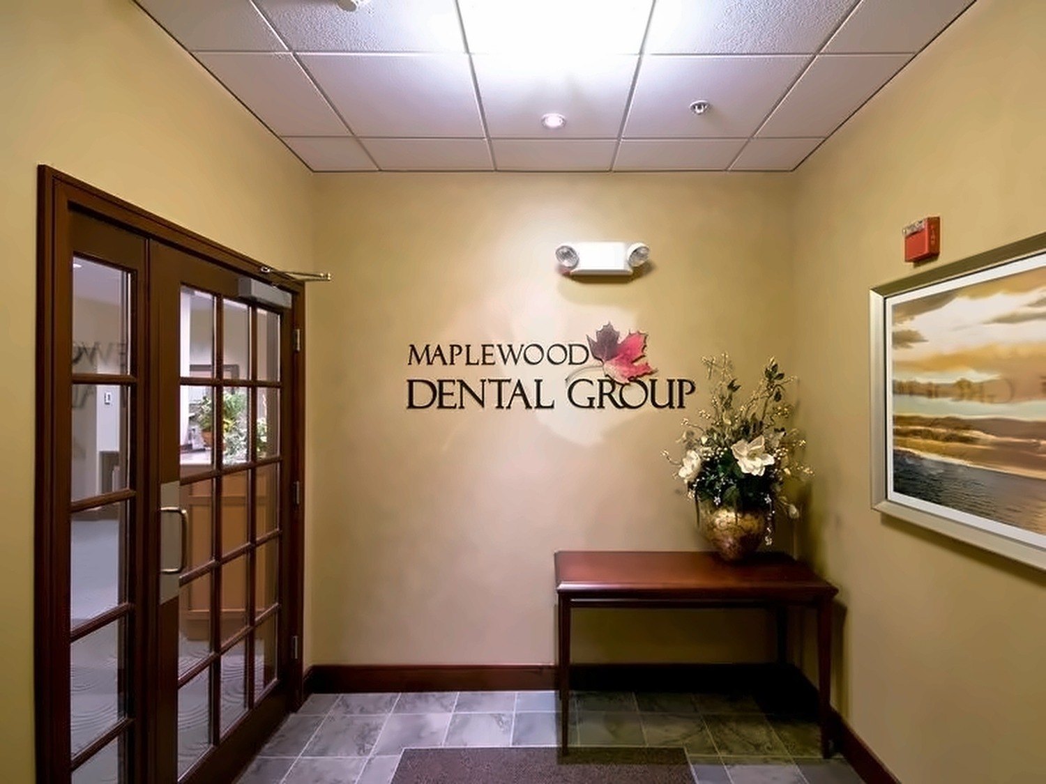 Entry lobby with wall signage and recessed lighting at Maplewood Dental Group in Nashua, New Hampshire