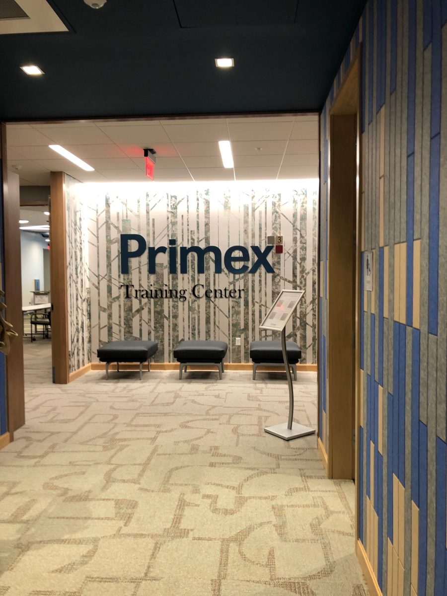 Primex Training Center lobby with birch pattern wall, recessed lighting and blue acoustic panels